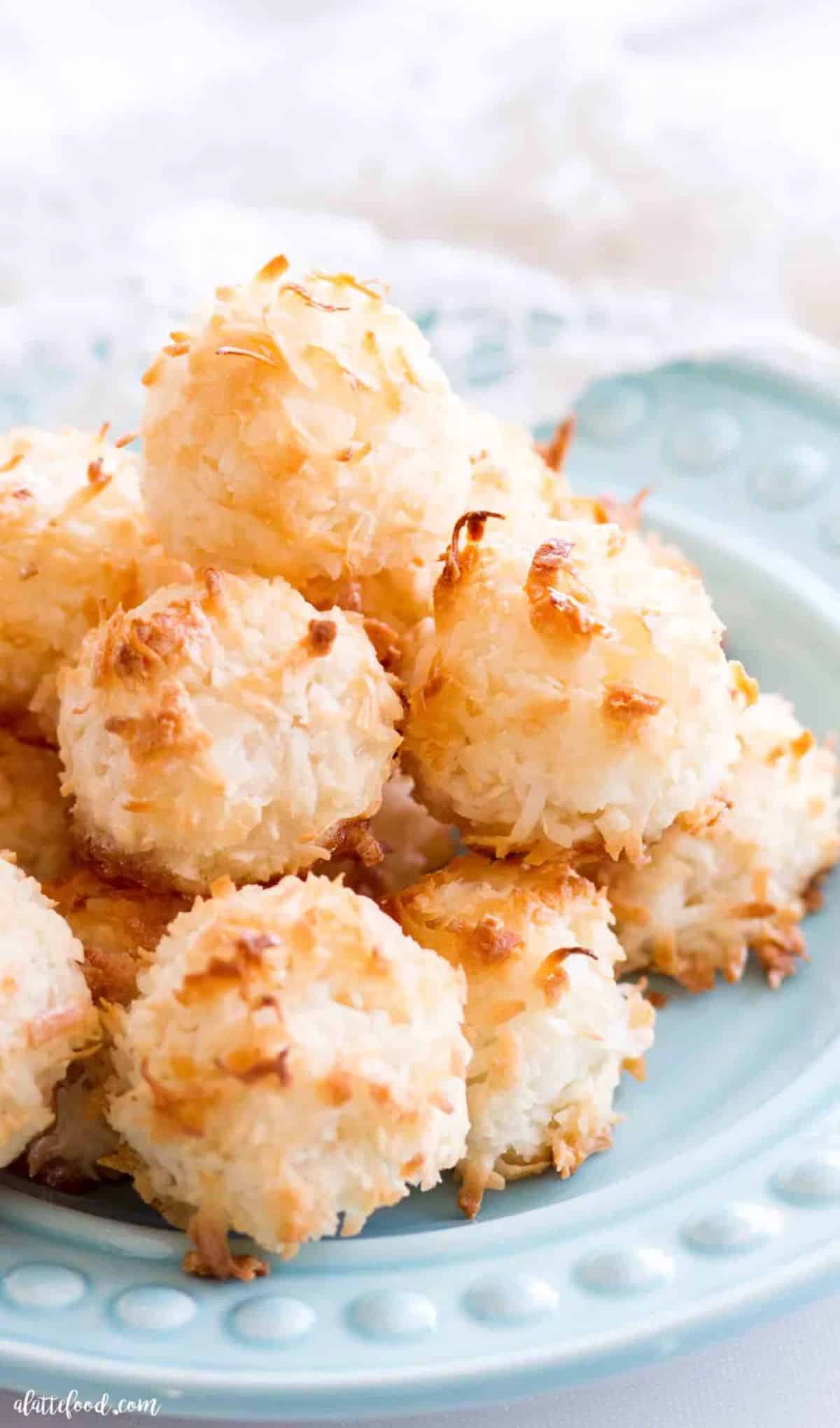 Crispy easy coconut macarons on a blue plate.