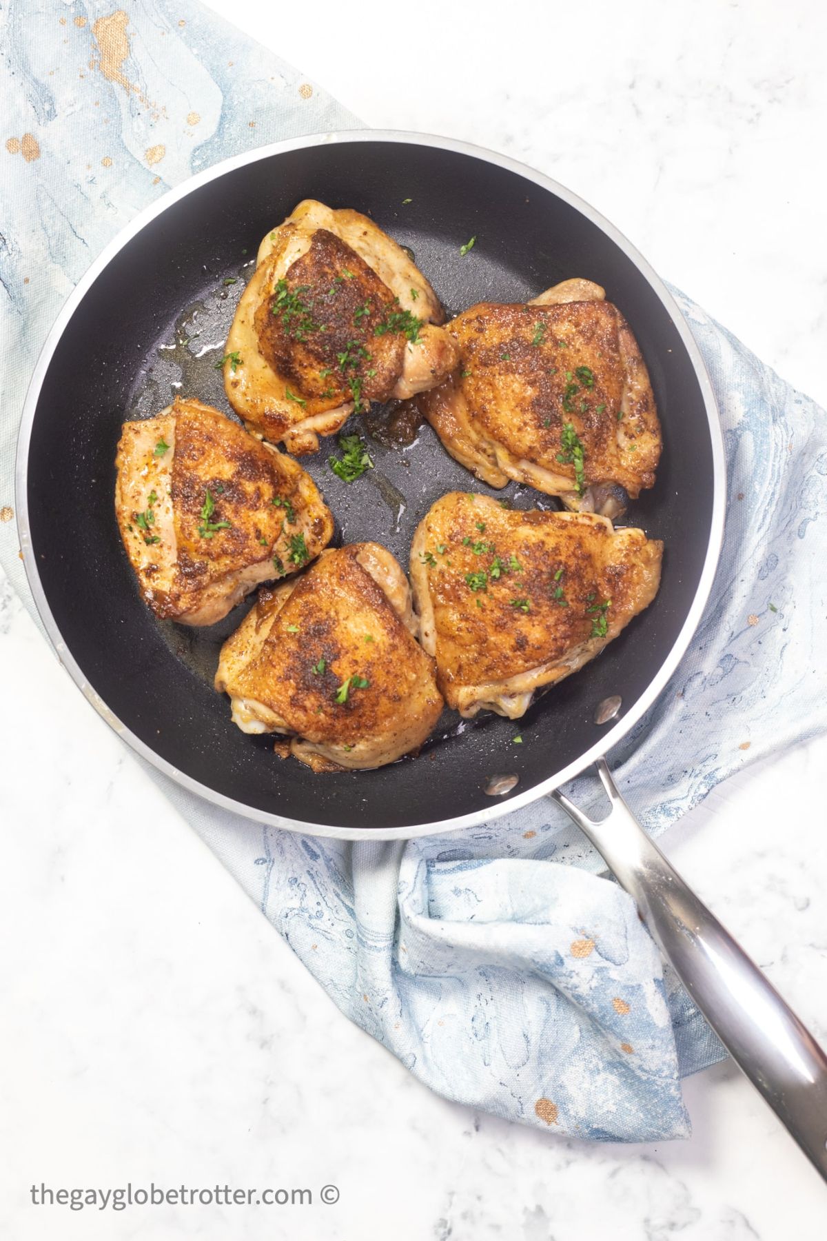 Flavorful old bay chicken thighs in a skillet.