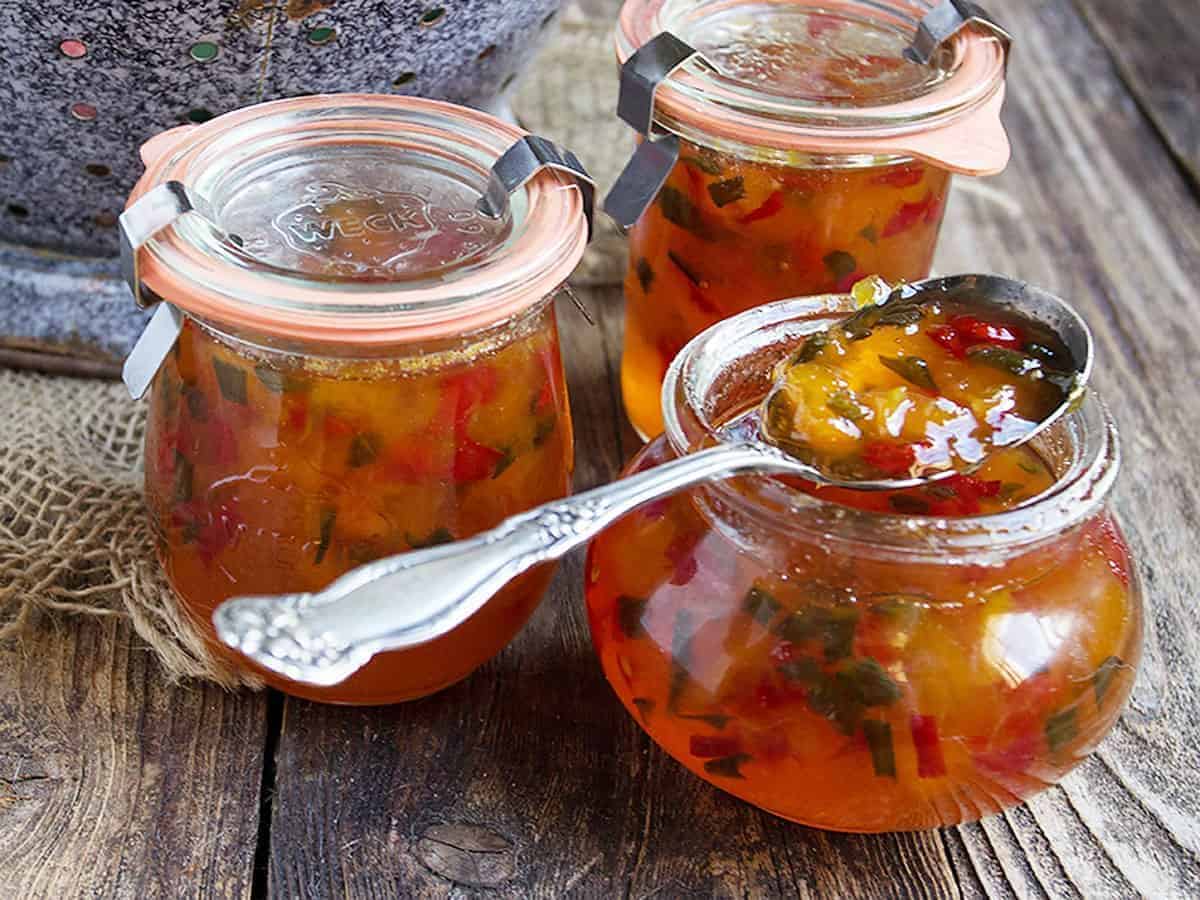 Spicy peach and pepper jam in glass jars.