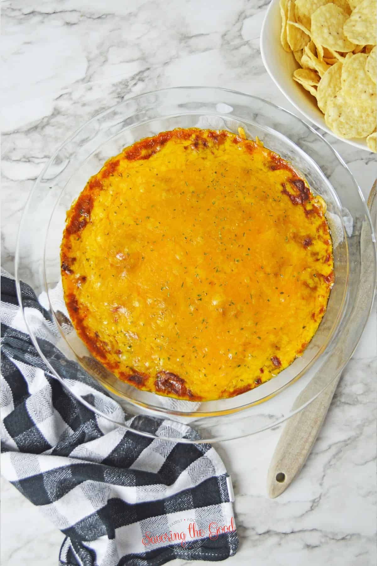 Creamy hormel chili cheese dip in a glass bowl.