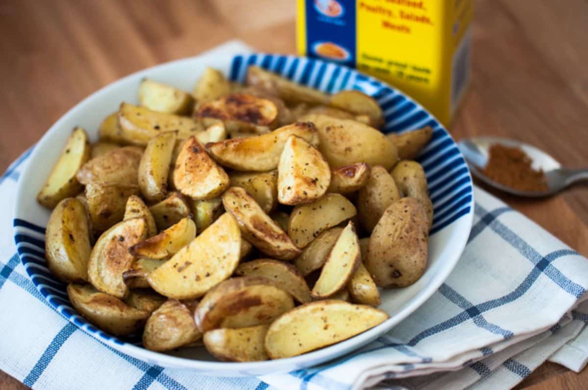 Tasty crispy, oven-roasted potatoes on a blue-white plate.