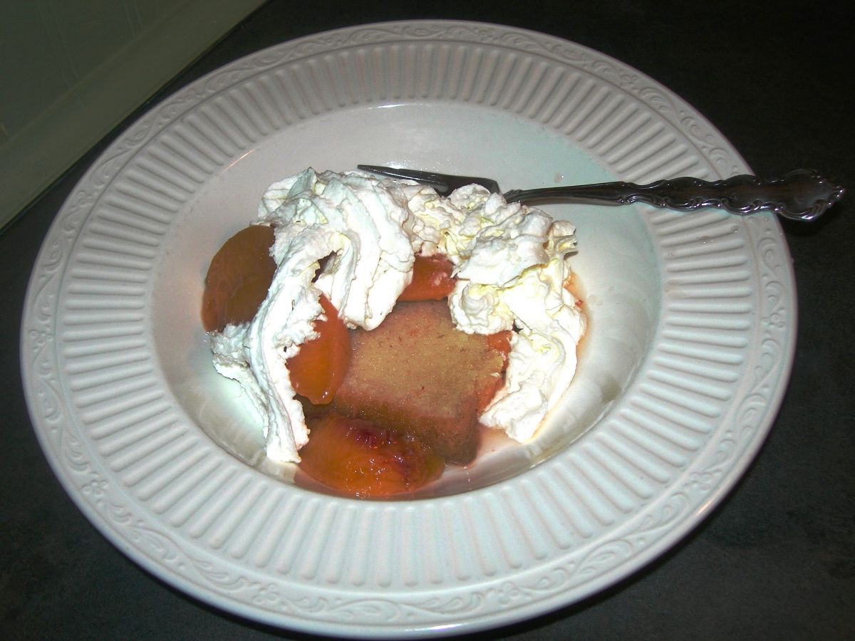 A piece of sarah's pound cake  with a fork on a white plate.