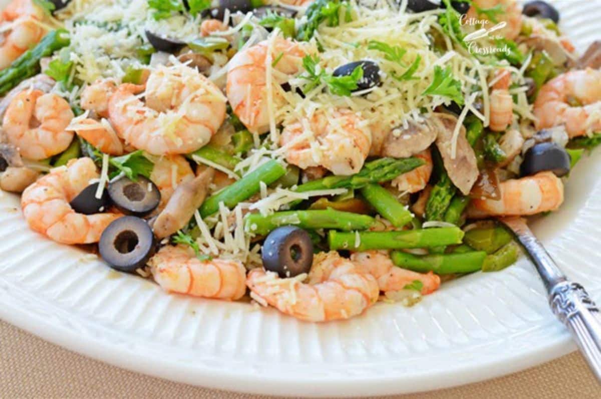 Healthy scrumptious shrimp pasta on a white plate.