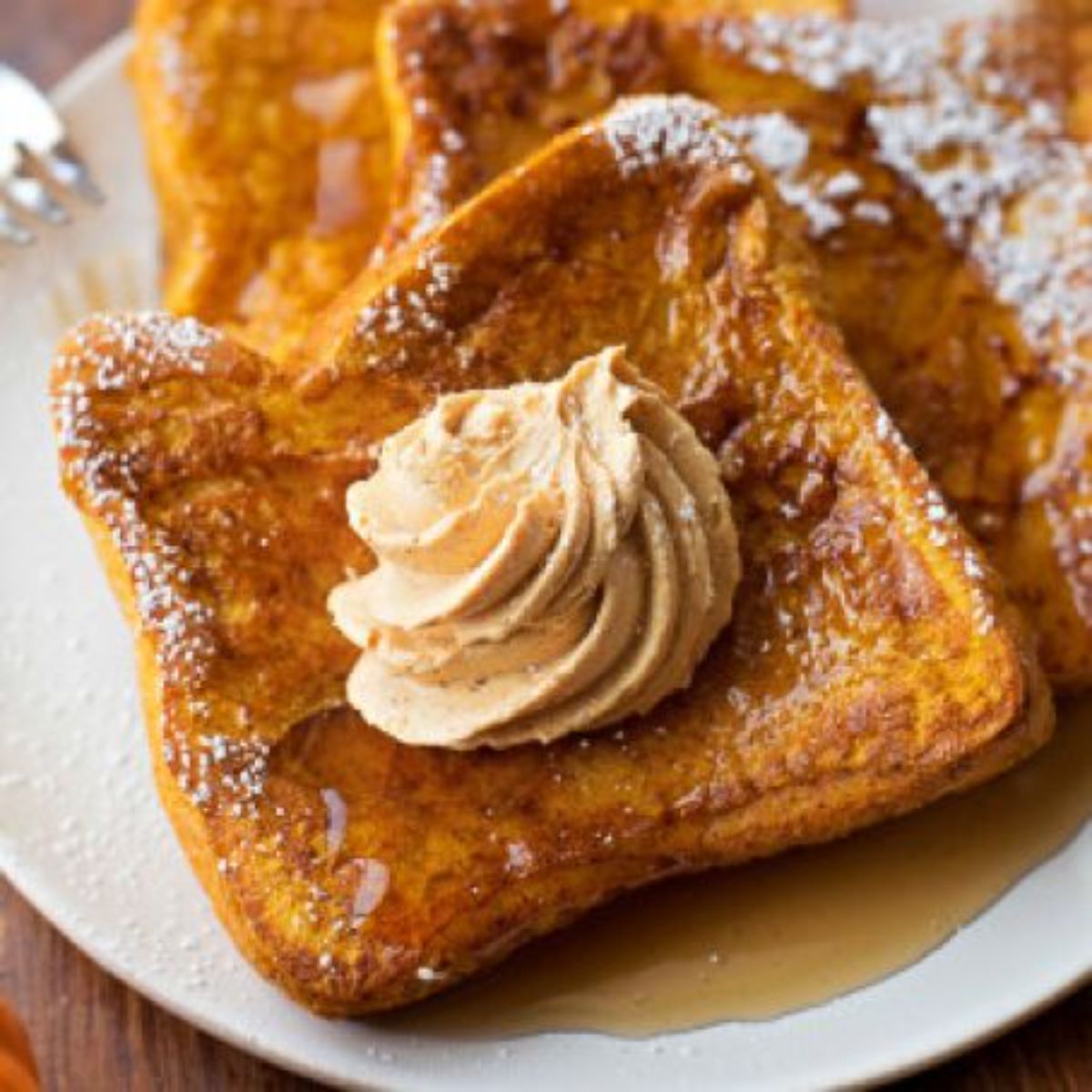 Delicious pumpkin butter french toast on a white plate.