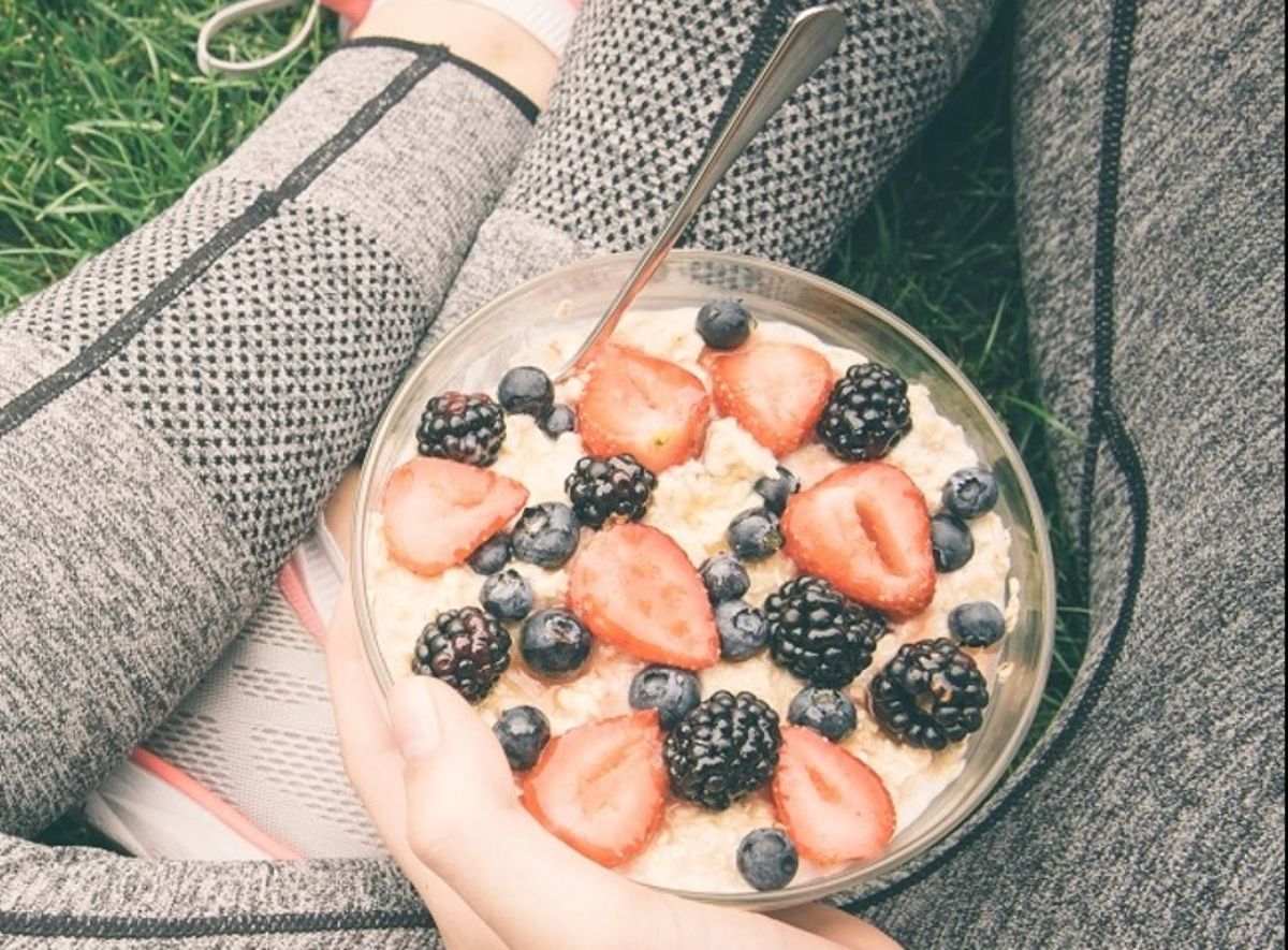 Healthy vanilla protein shake in a glass bowl with a spoon.