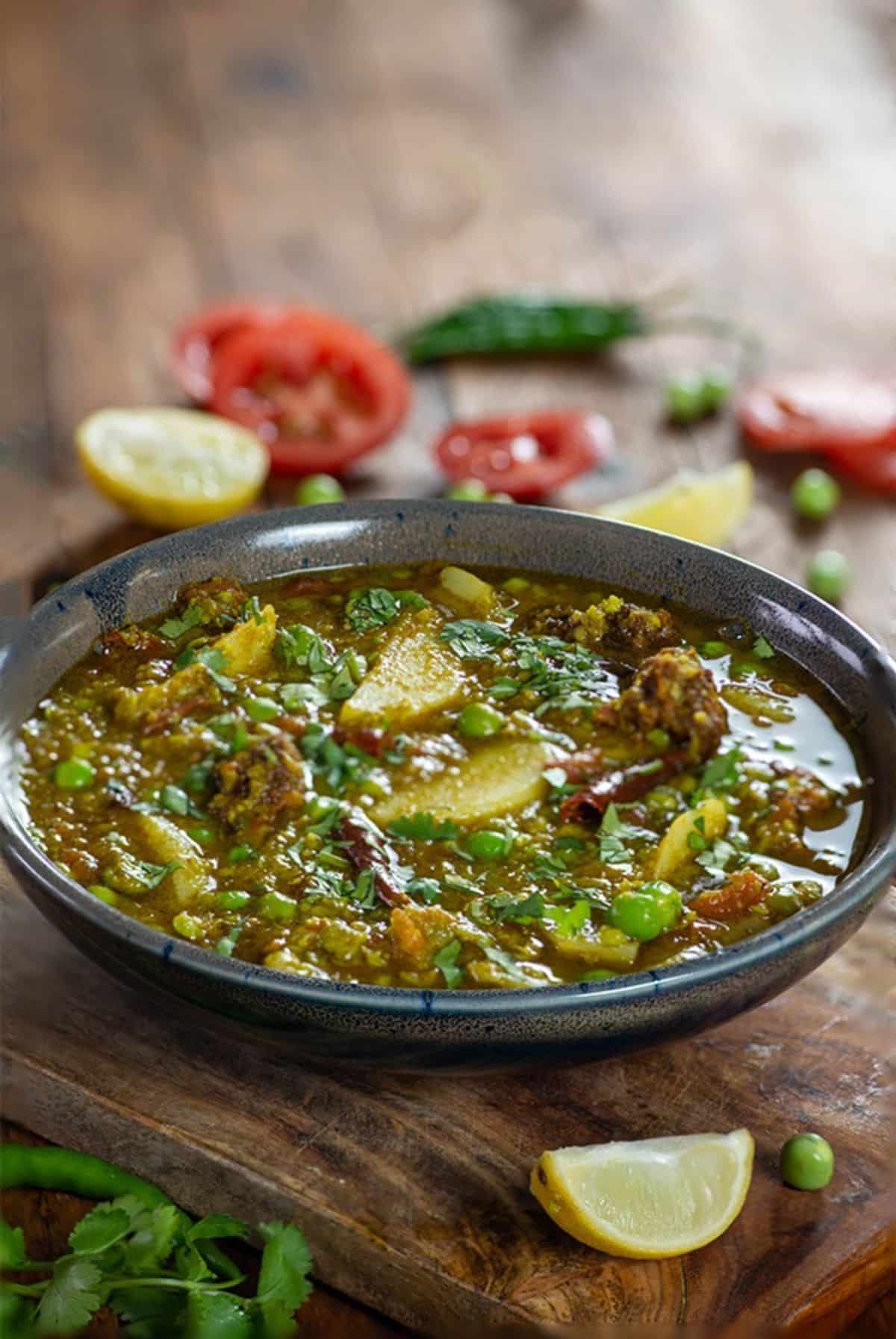 Delicious green peas curry in a gray bowl.