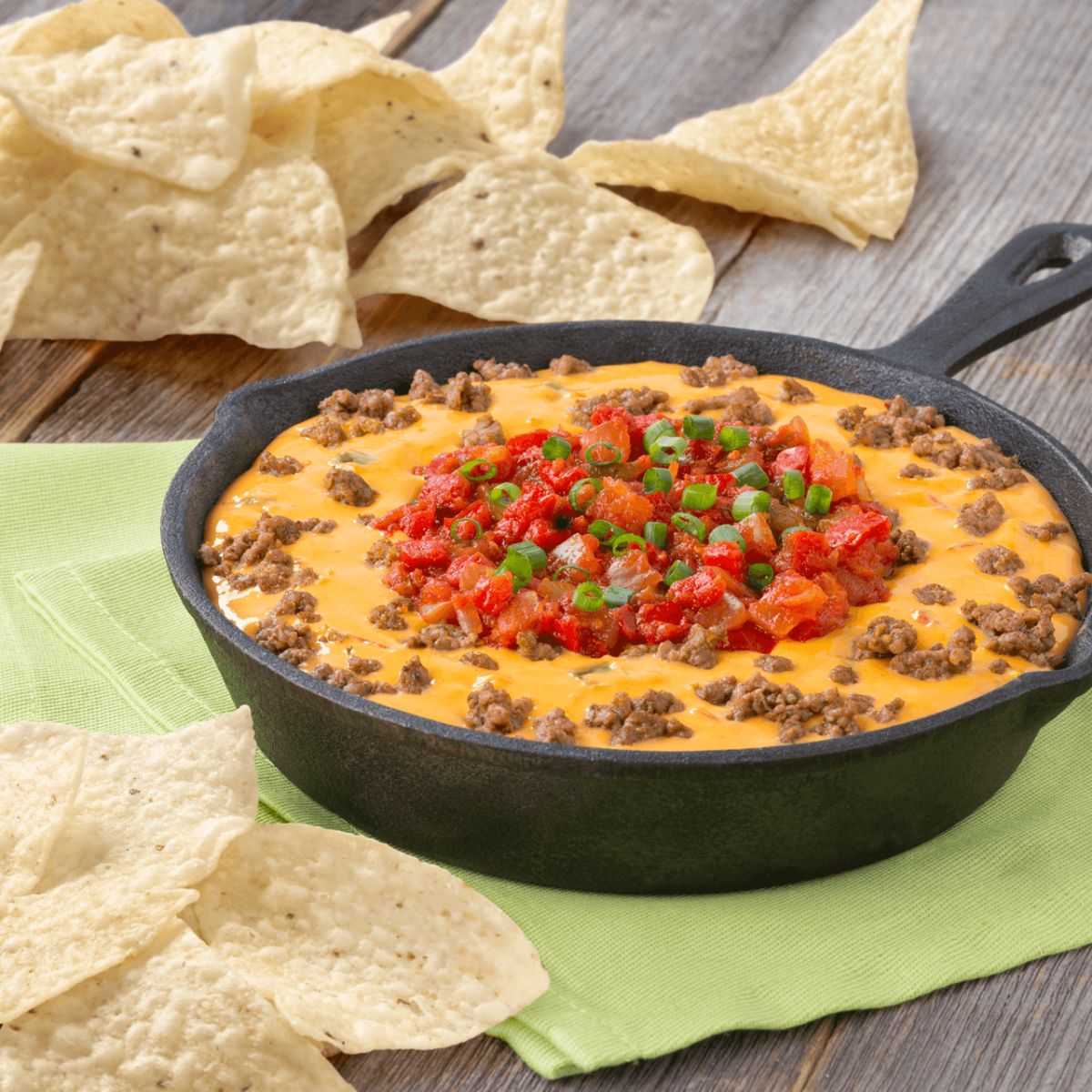 Flavorful queso fundido dip in a black skillet.