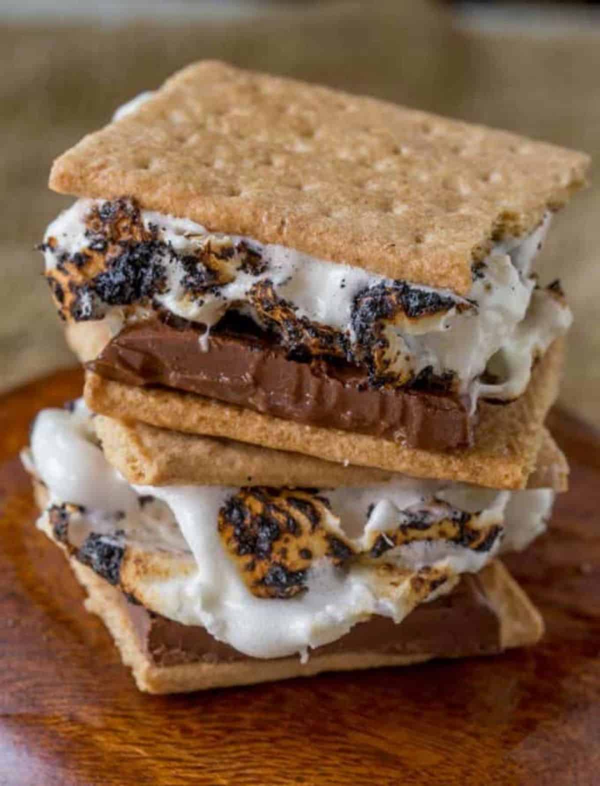 Scumptious s’mores cookies on a wooden tray.