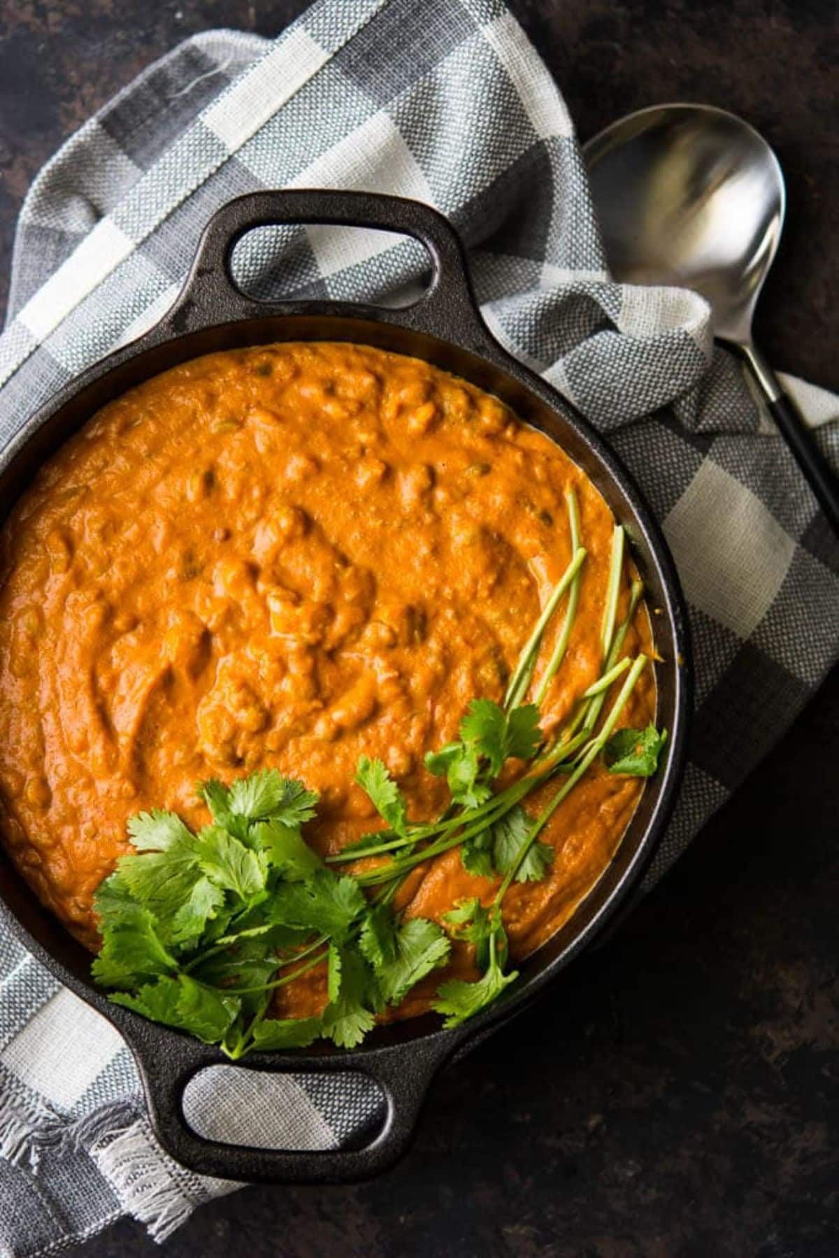 Hearty split pea curry in a black bowl.