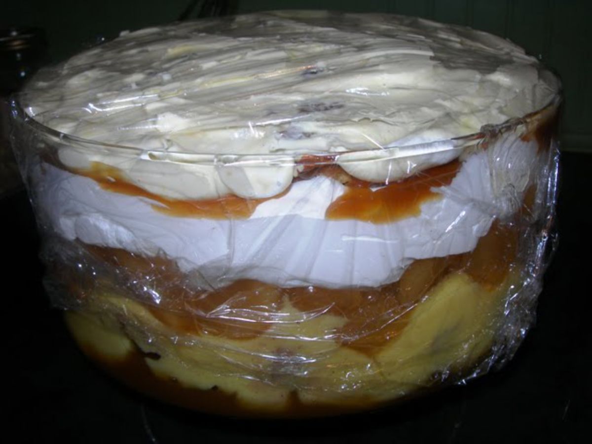 Scrumptious colossal caramel apple trifle in a glass bowl.