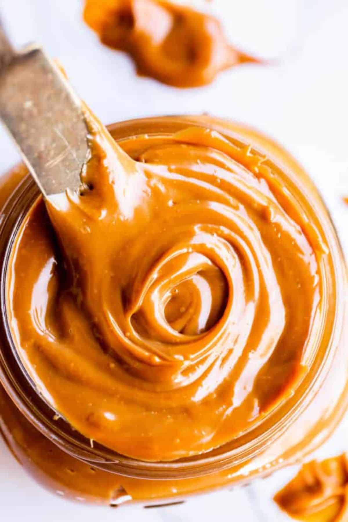 Creamy dulce de leche in a glass jar.