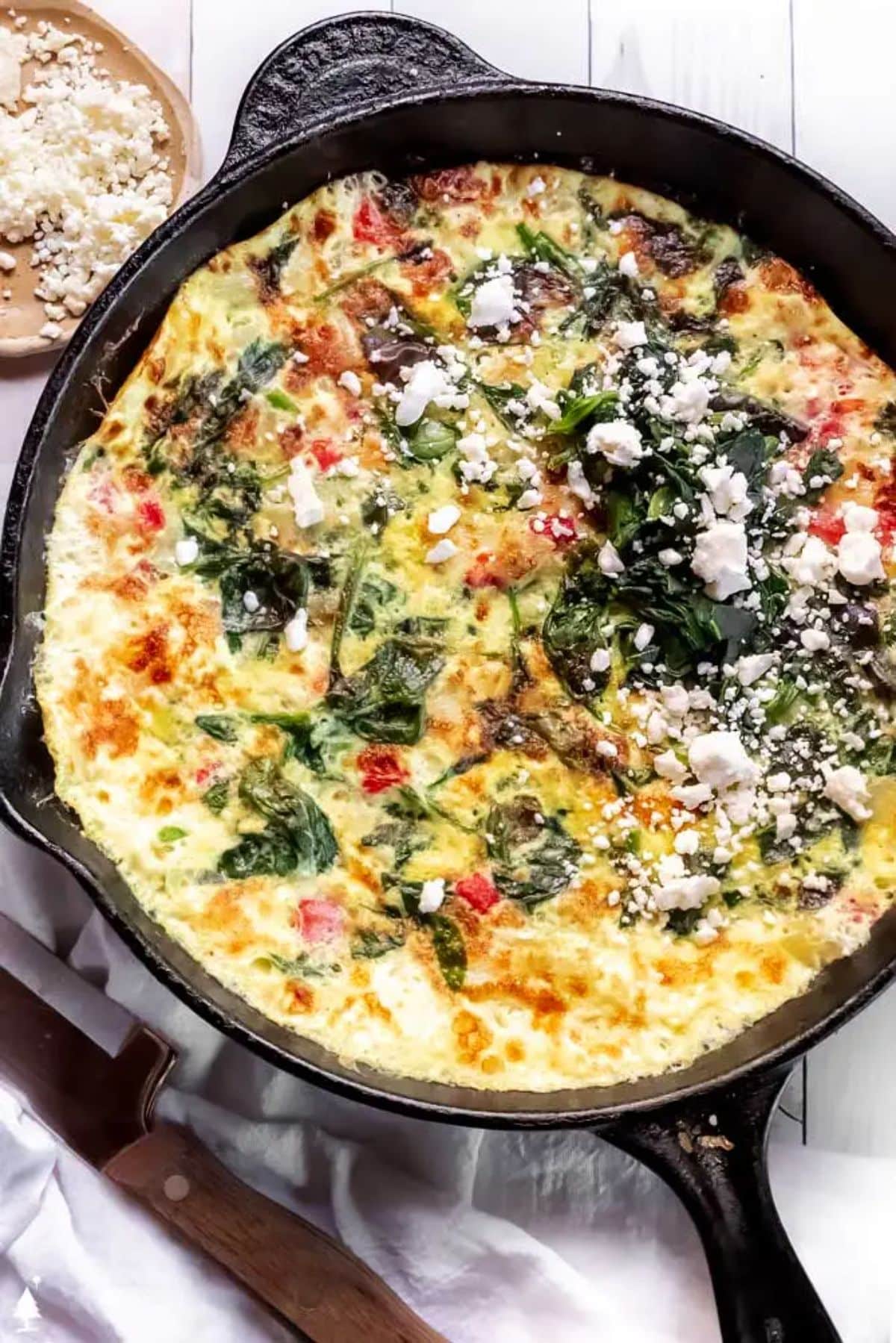 Healthy egg white frittata in a black skillet.