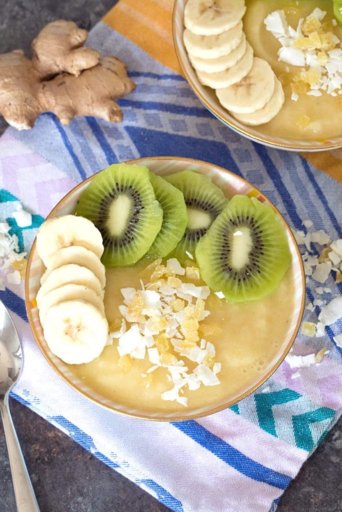 Creamy pineapple and banana ginger smoothie in a bowl.