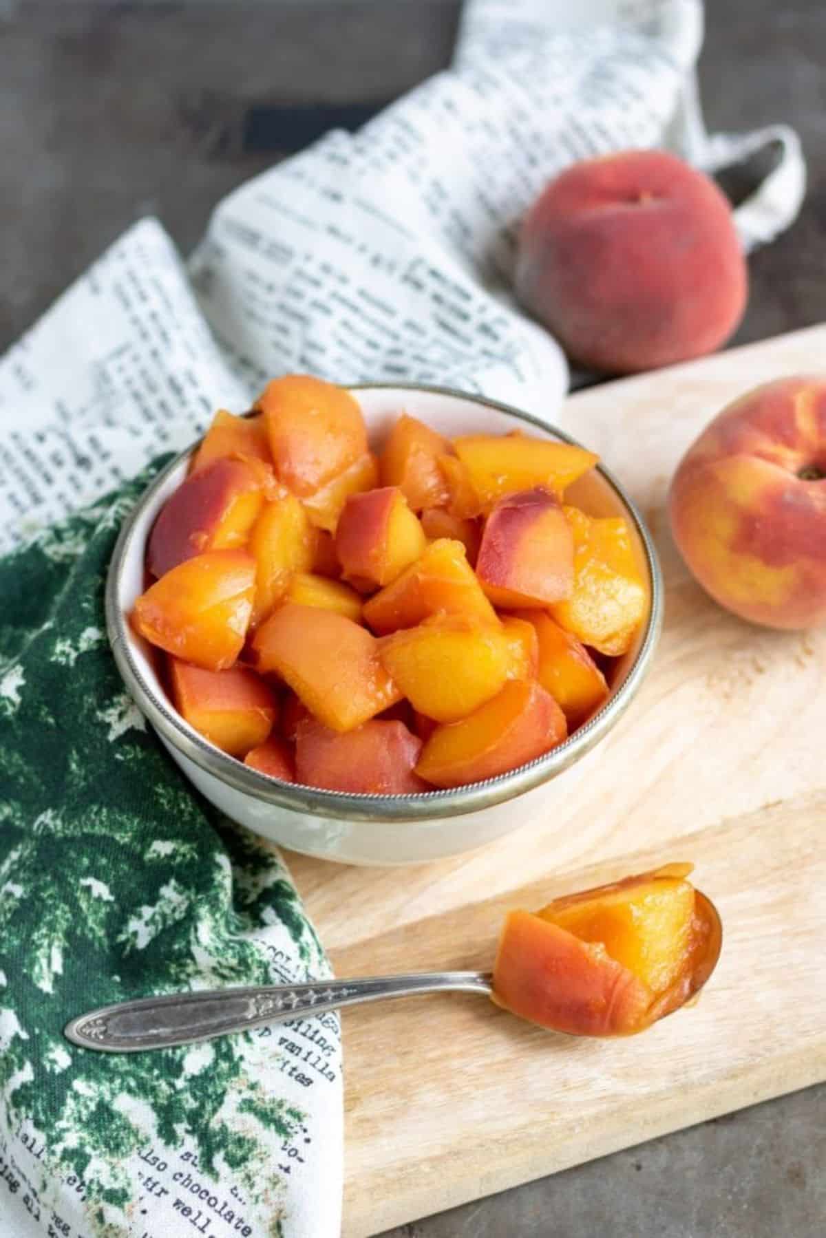 Juicy easy peach compote in a small bowl.