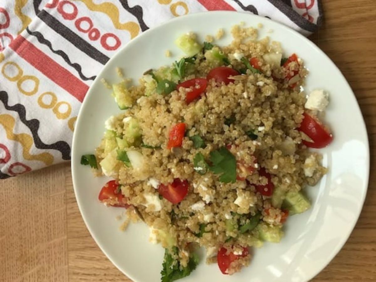 Healthy quinoa salad on a white plate.