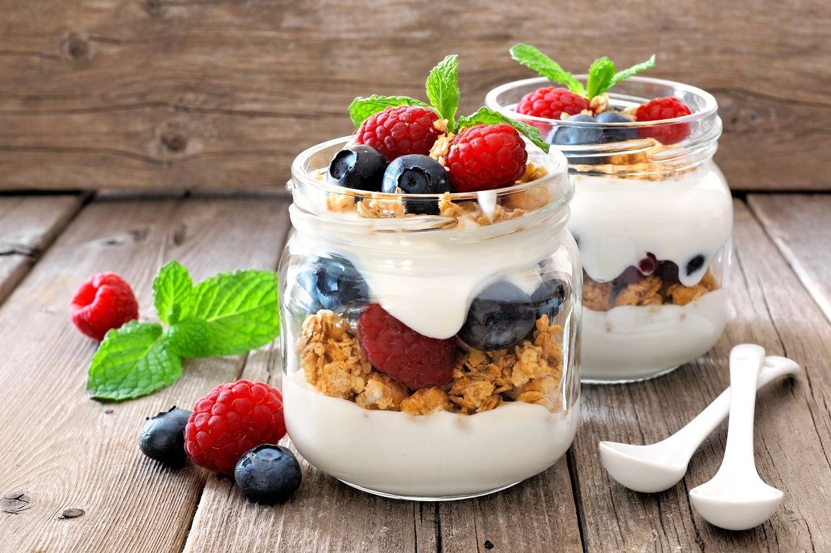 Mouth-watering berry parfait in glass jars.