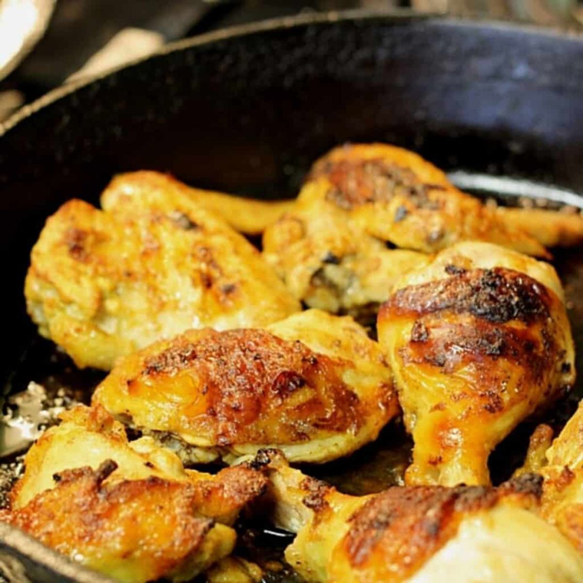 Crispy greek yogurt chicken in a black skillet.