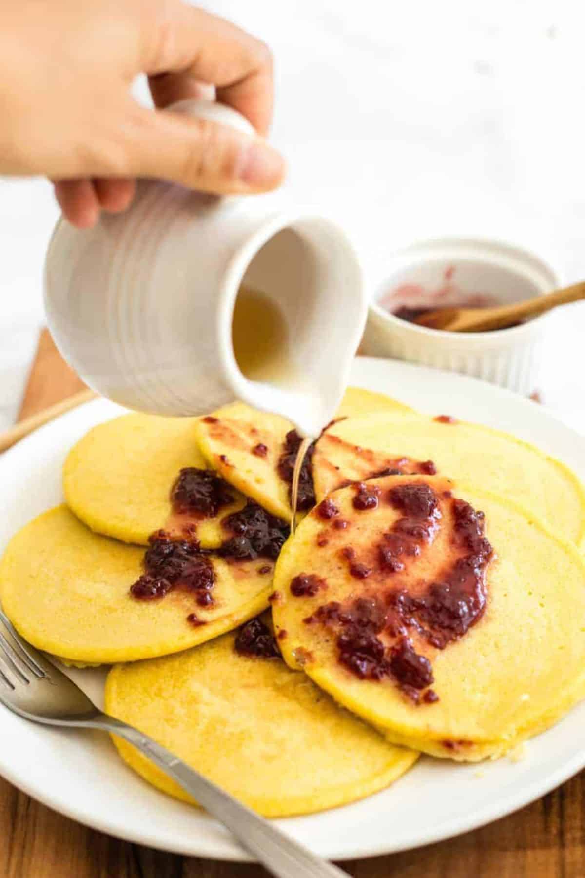 Delicious corn flour pancakes drizzled with syrup.