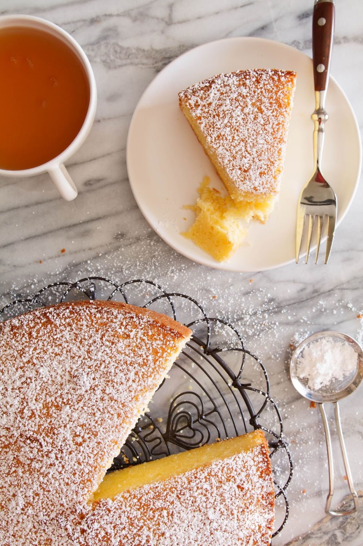 Scrumptious passion fruit yogurt cake on a cake tray and on a white plate.