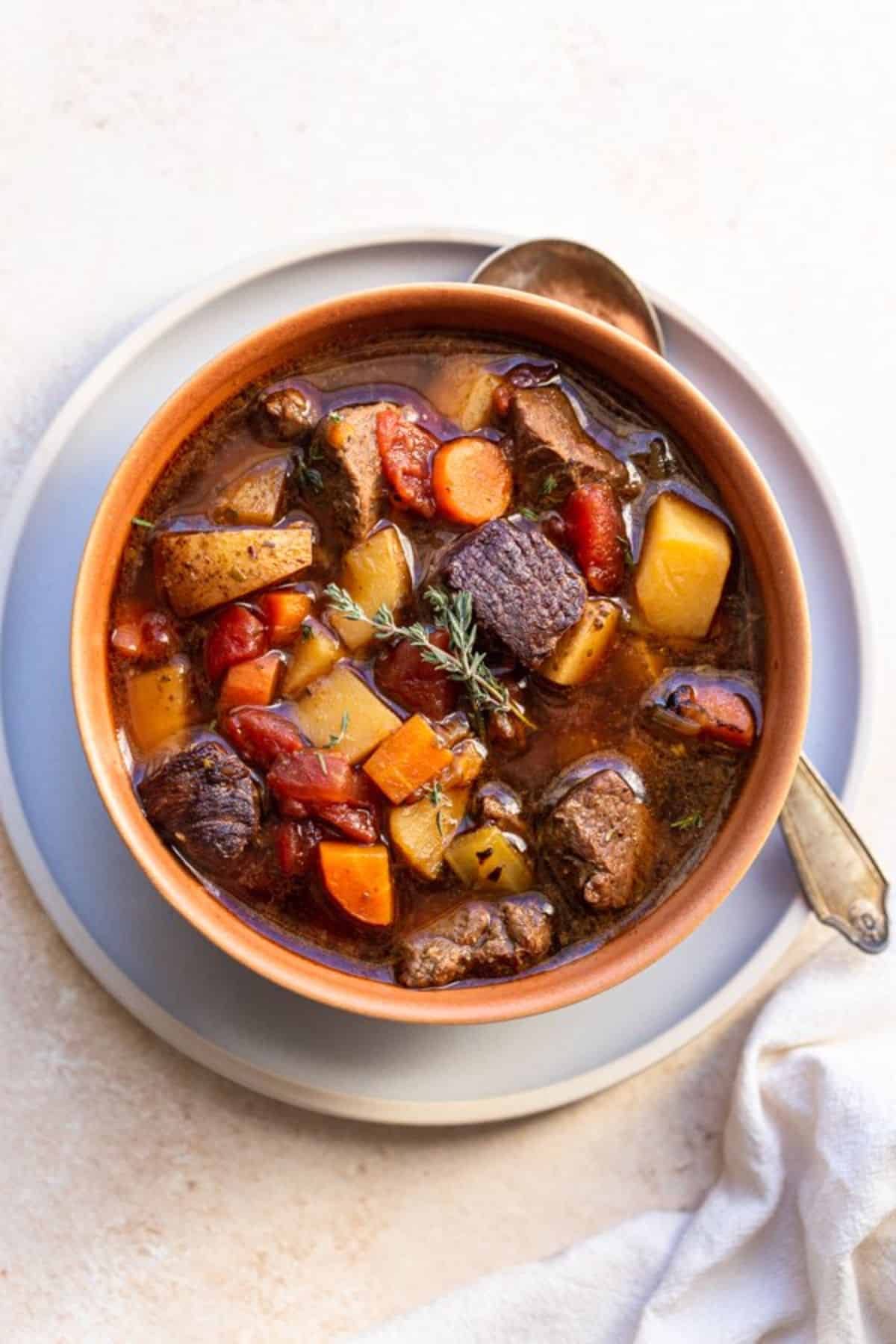Healthy venison stew in an orange bowl.