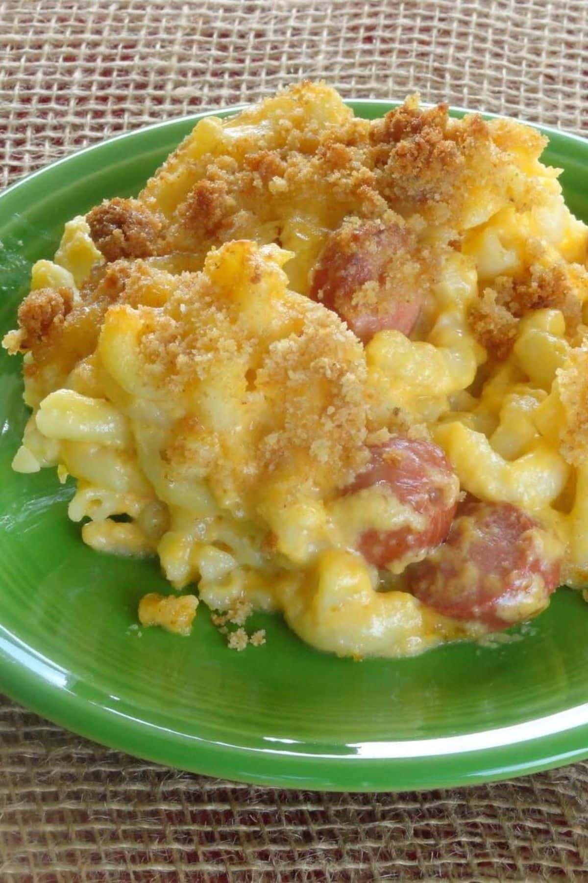 Delicious hot dog mac n’ cheese on a green plate.