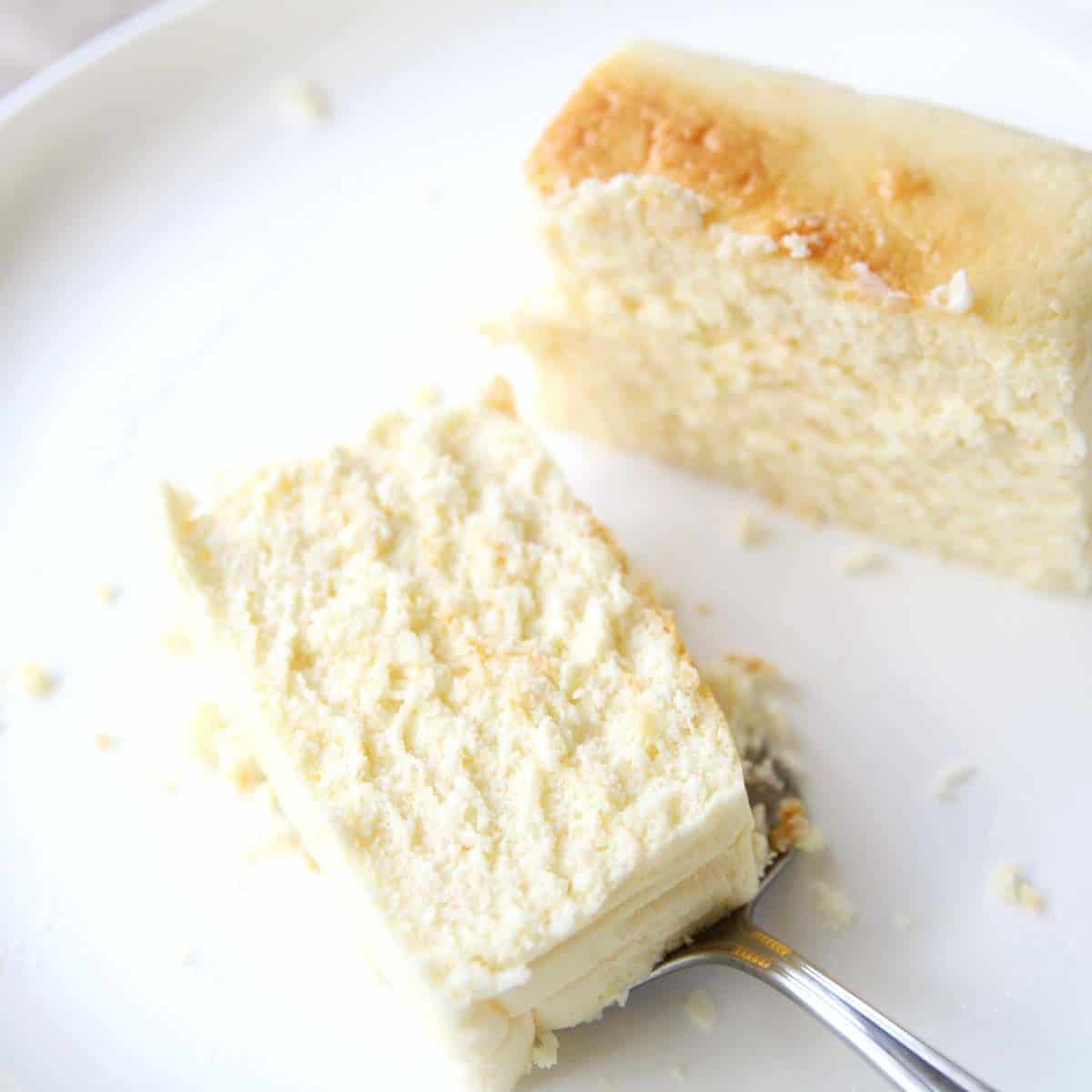 A piece of  japanese cotton cheesecake with tofu on a white plate.