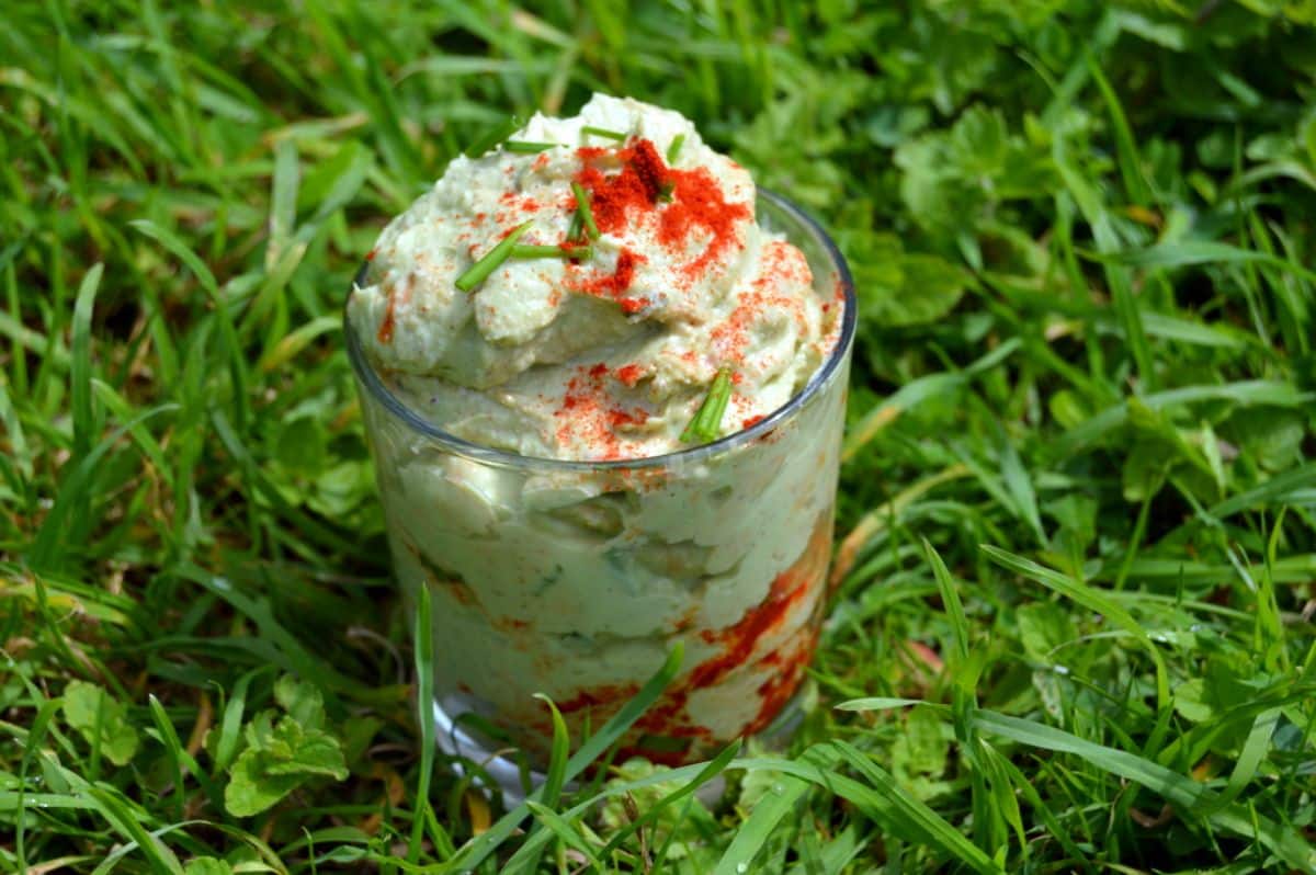 Creamy avocado and brazil nut mayonnaise in a glass cup.
