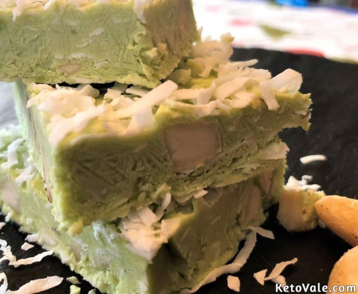 A pile of avocado ice cream bars on a black tray.