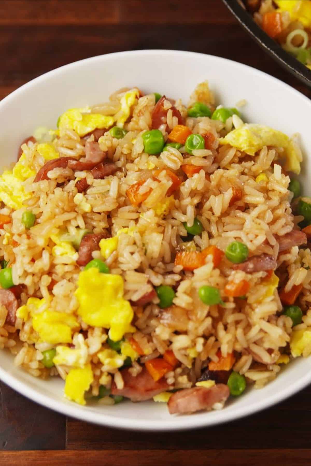 Healthy hot dog fried rice in a white bowl.