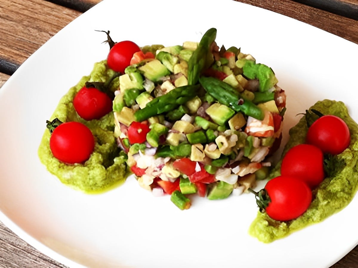 Healthy shrimp tartare with avocado on a white plate.