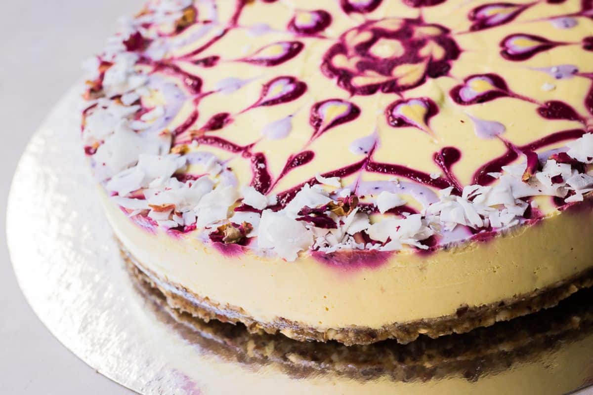 Scrumptious raw passion fruit swirl cake on a cake tray.