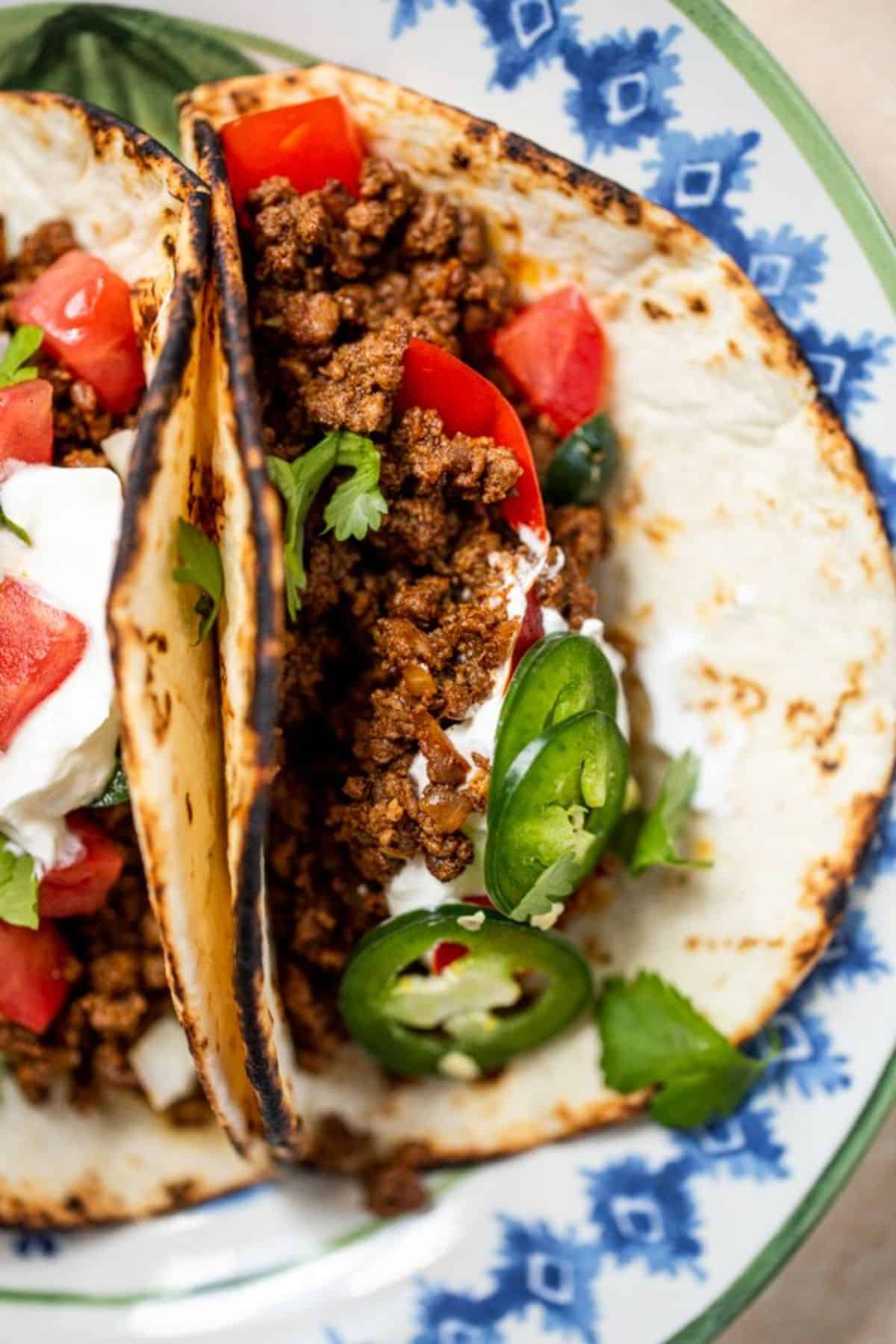 Mouth-watering ground venison tacos on a tray.