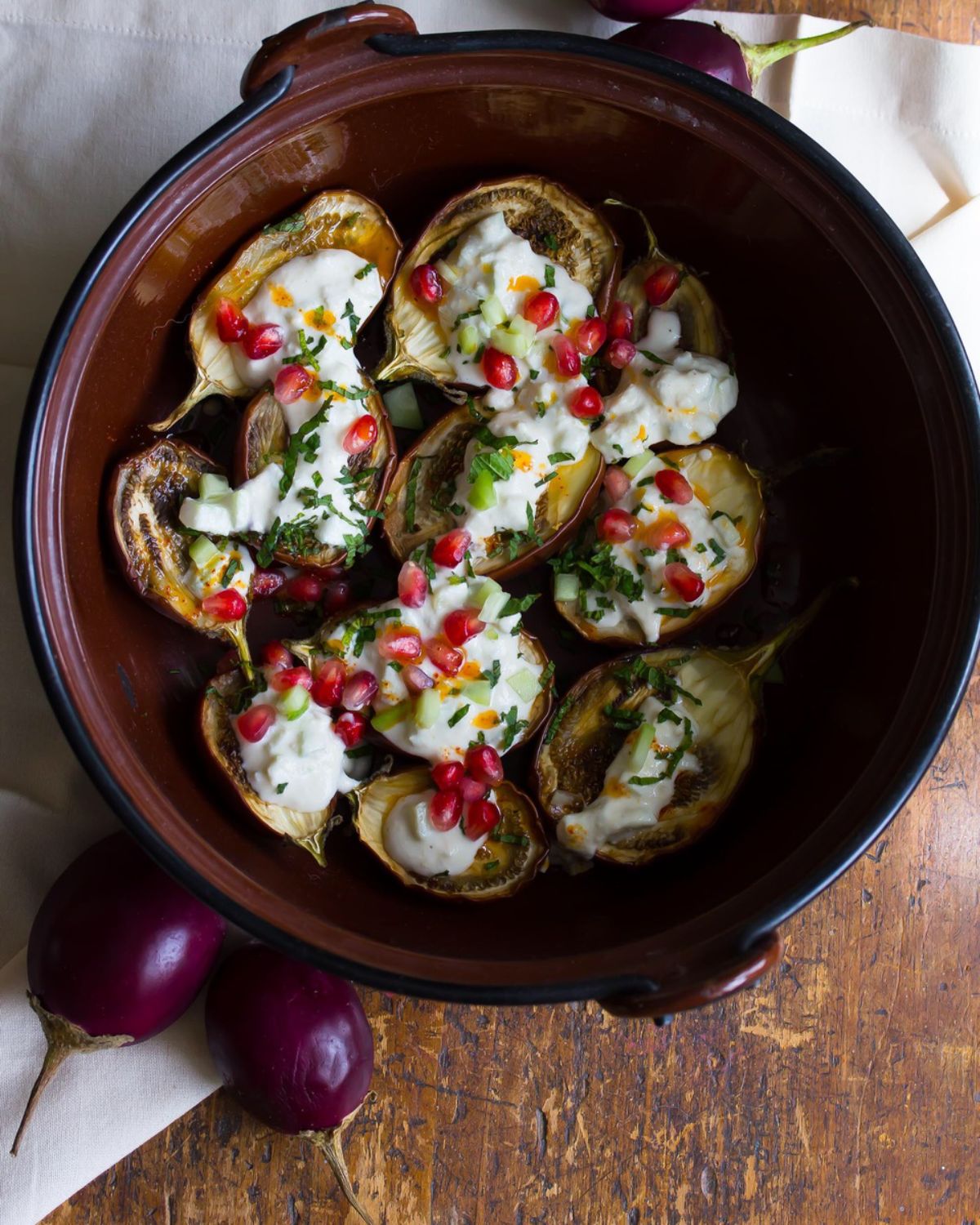 Delicious roasted baby eggplant with vegan cashew yogurt in a pot.