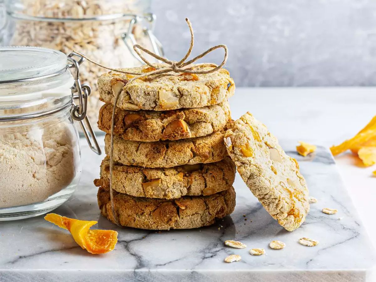 A pile of mango coconut cookies on a countertop.