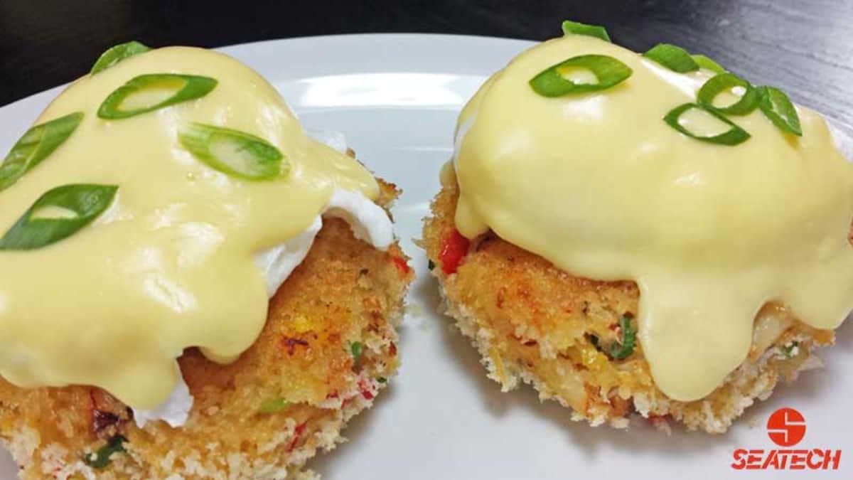 Flavorful crab cakes, eggs benedict on a white tray.