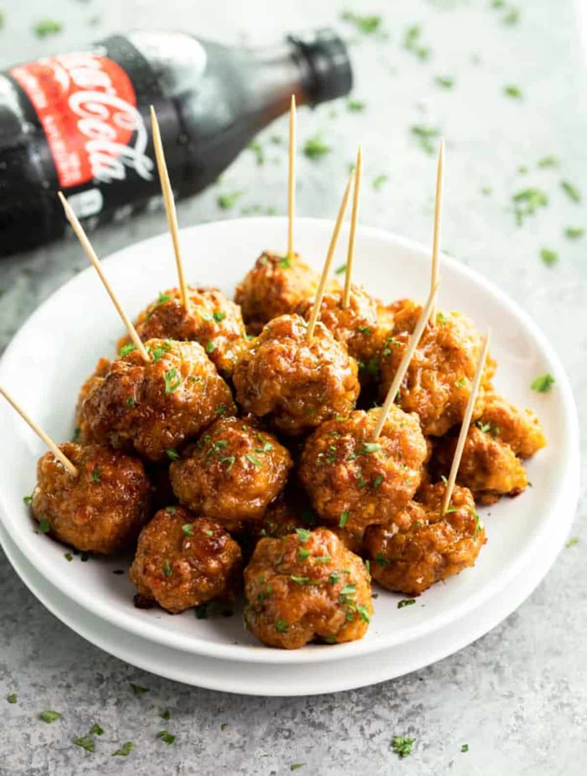 Juicy spicy sausage balls in a white bowl.