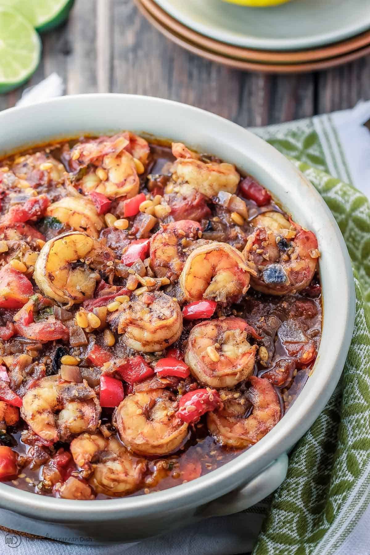 Tasty baked shrimp stew in a gray bowl.