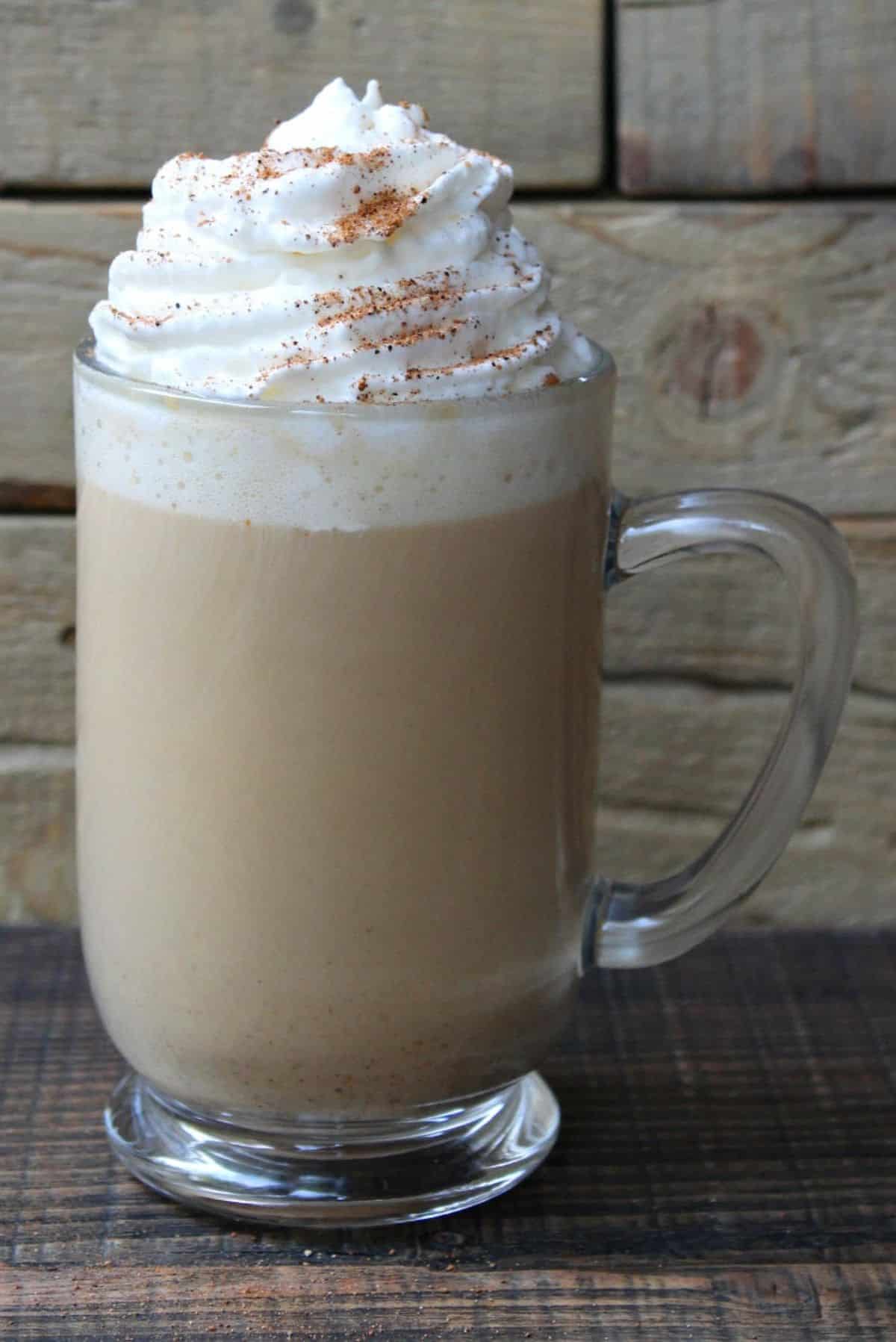 Creamy pumpkin spice latte in a glass cup.