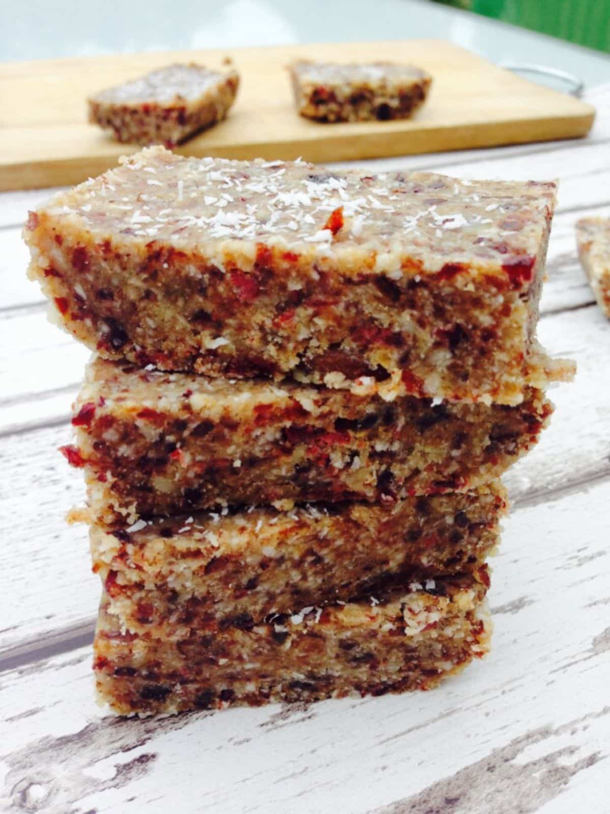 A pile of granola bars on a wooden table.