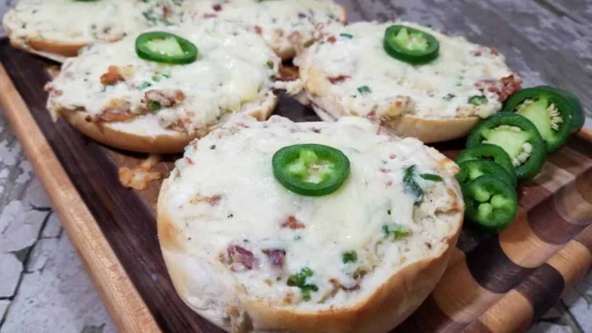 Juicy jalapeno popper bagels on a wooden tray.
