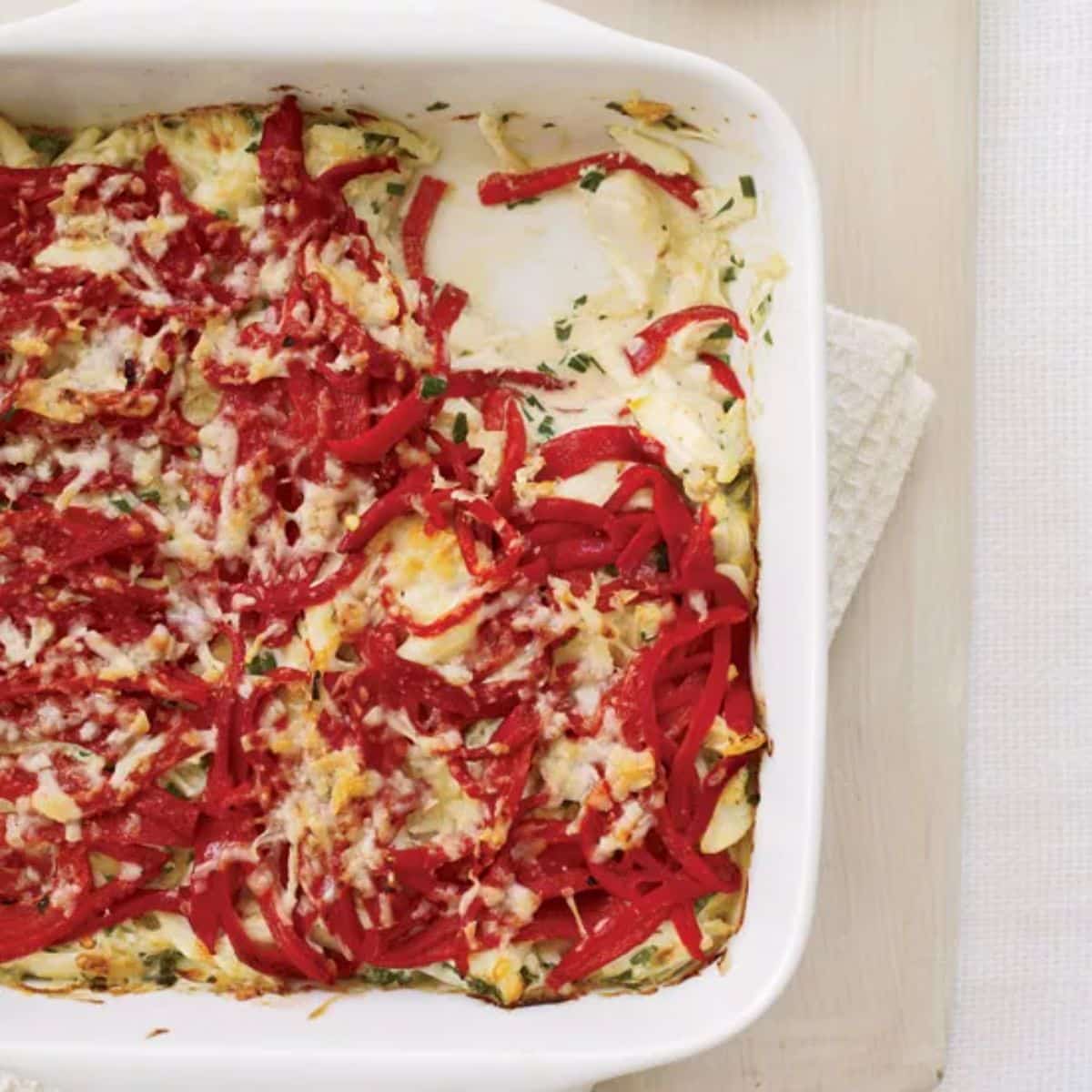 Creamy piquillo and crab dip in a white casserole.