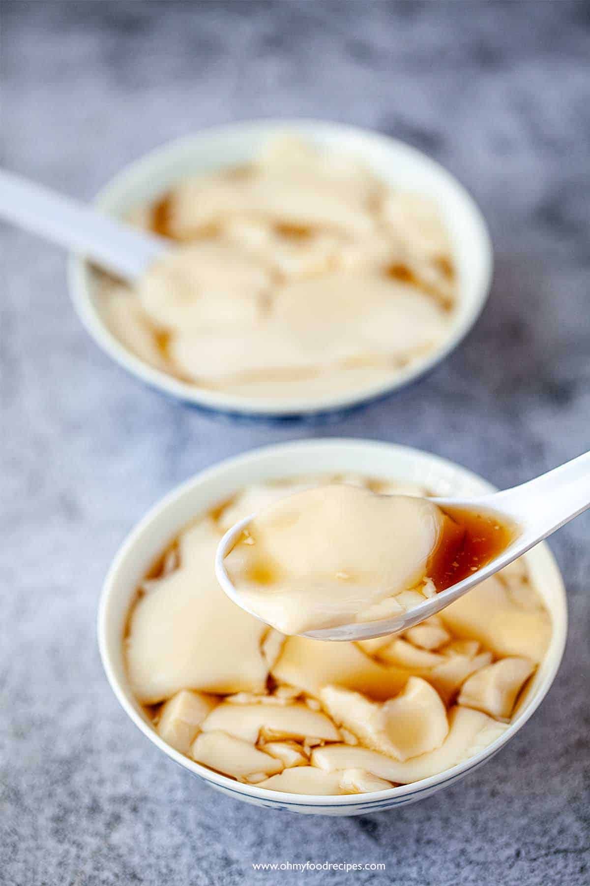 Delicious soy bean curd dessert in white bowls.