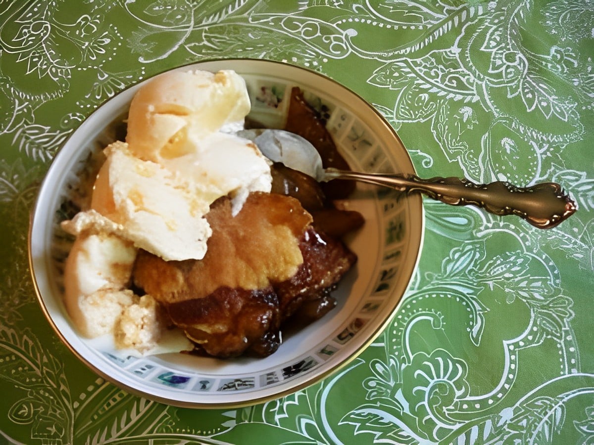 Delicious jane’s pear puff in a bowl with a spoon.