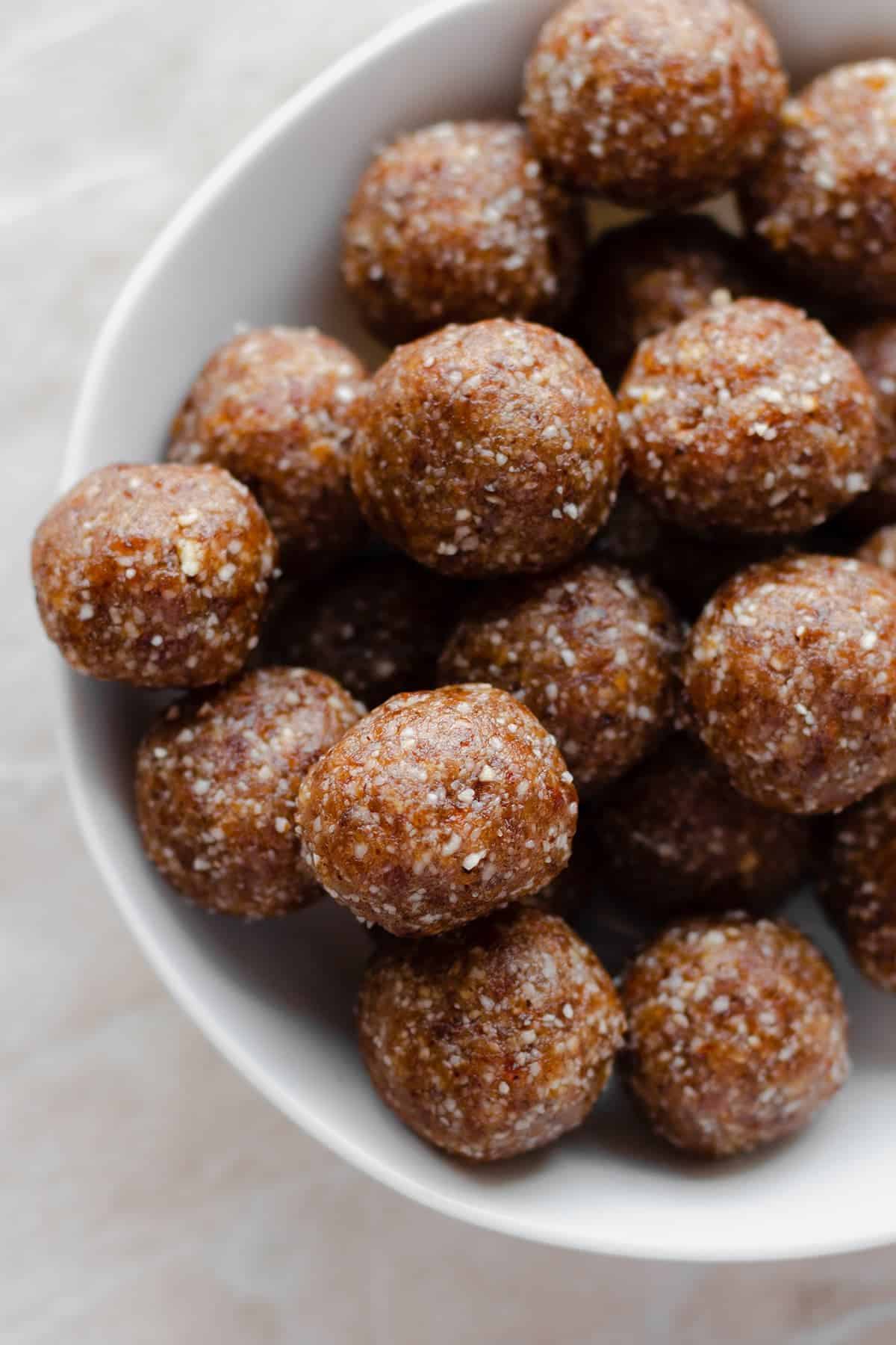 Scrumptious apricot brazil nut energy balls in a white bowl.