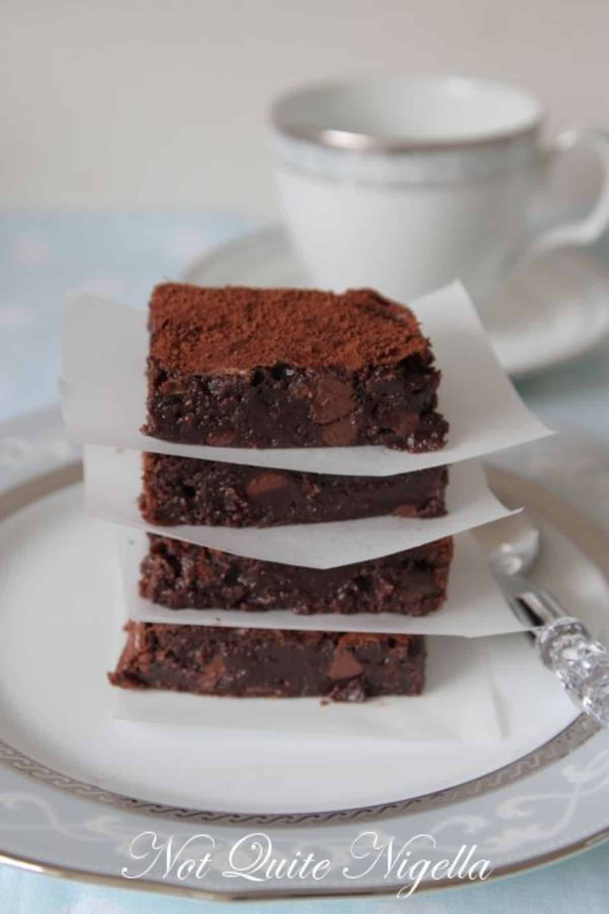 A pile of chocolate chestnut brownies on a plate.
