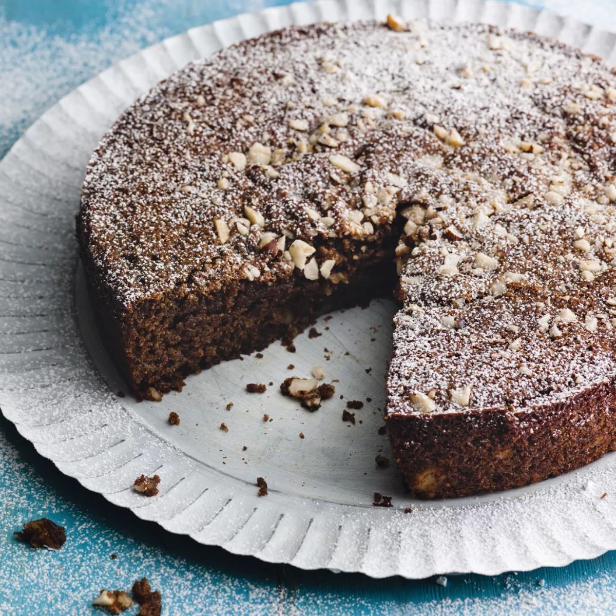 Flavorful coffee and brazil nut yogurt cake on a tray.