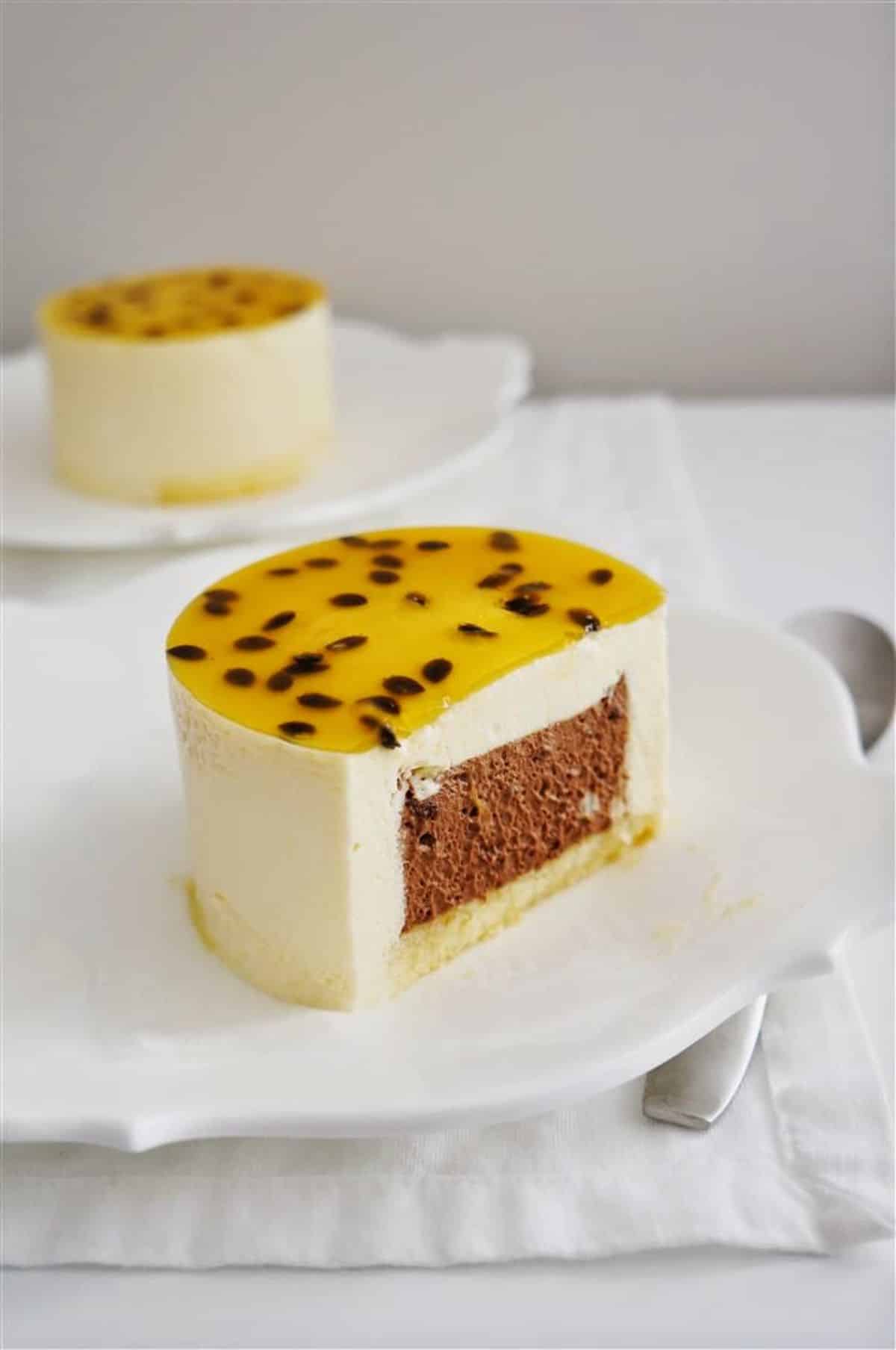 Mouth-watering passion fruit and chocolate entremet on a cake tray.