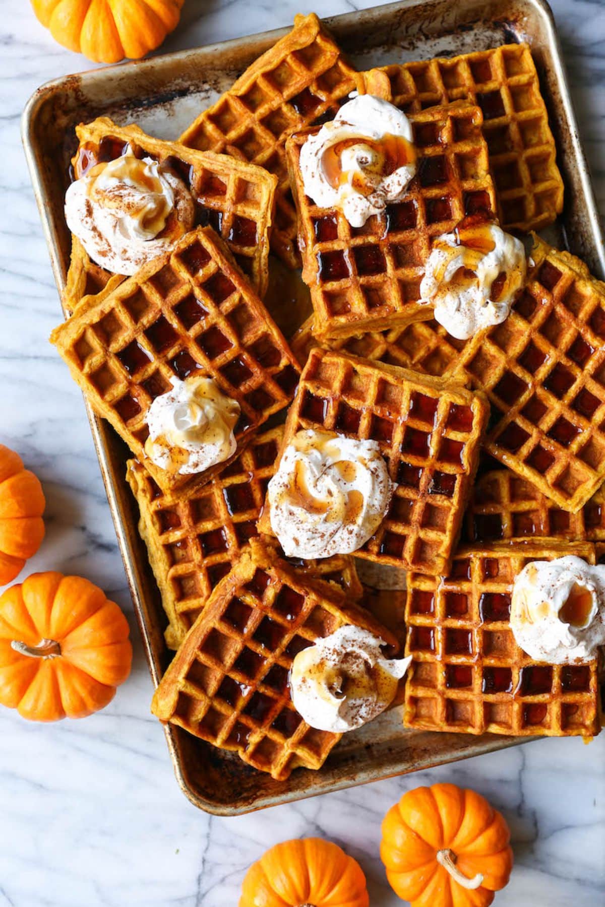 Mouth-watering pumpkin spice waffles on a baking tray.