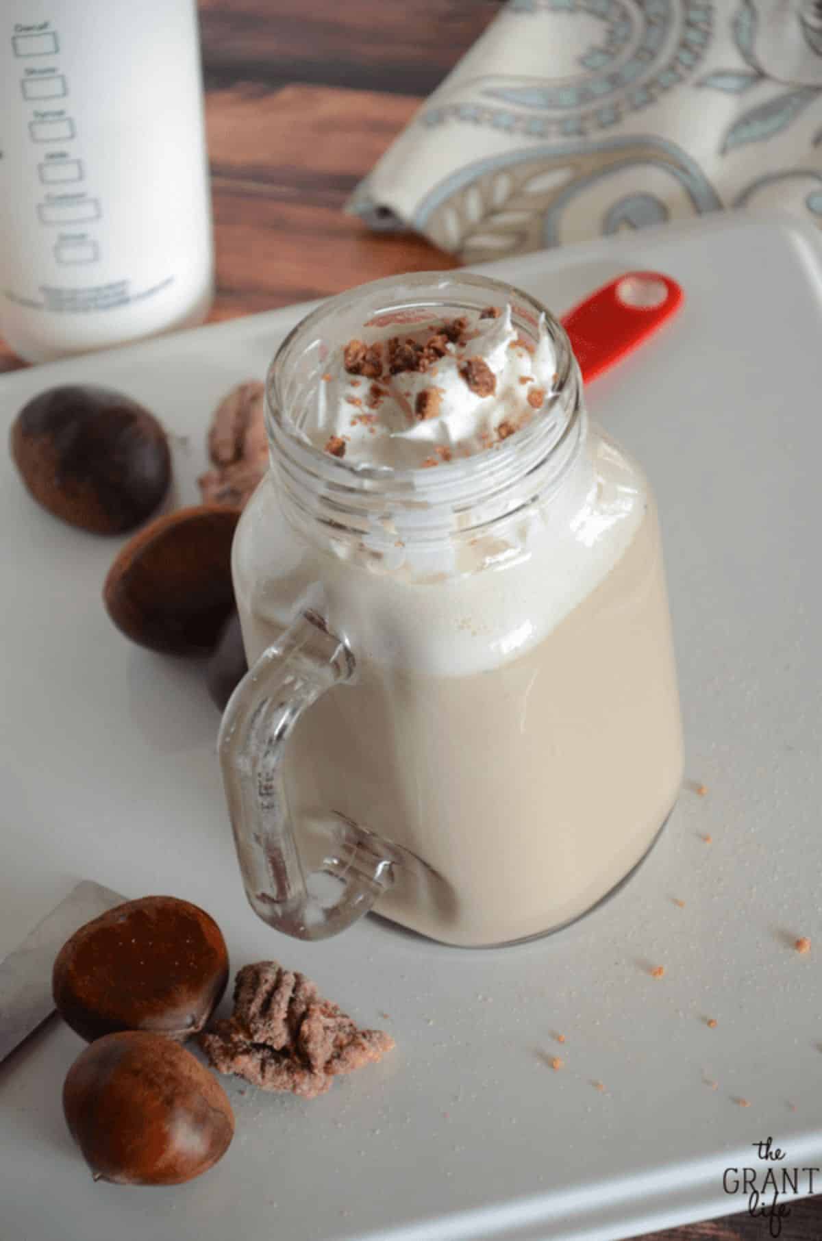Fresh chestnut praline latte in a glass jar.