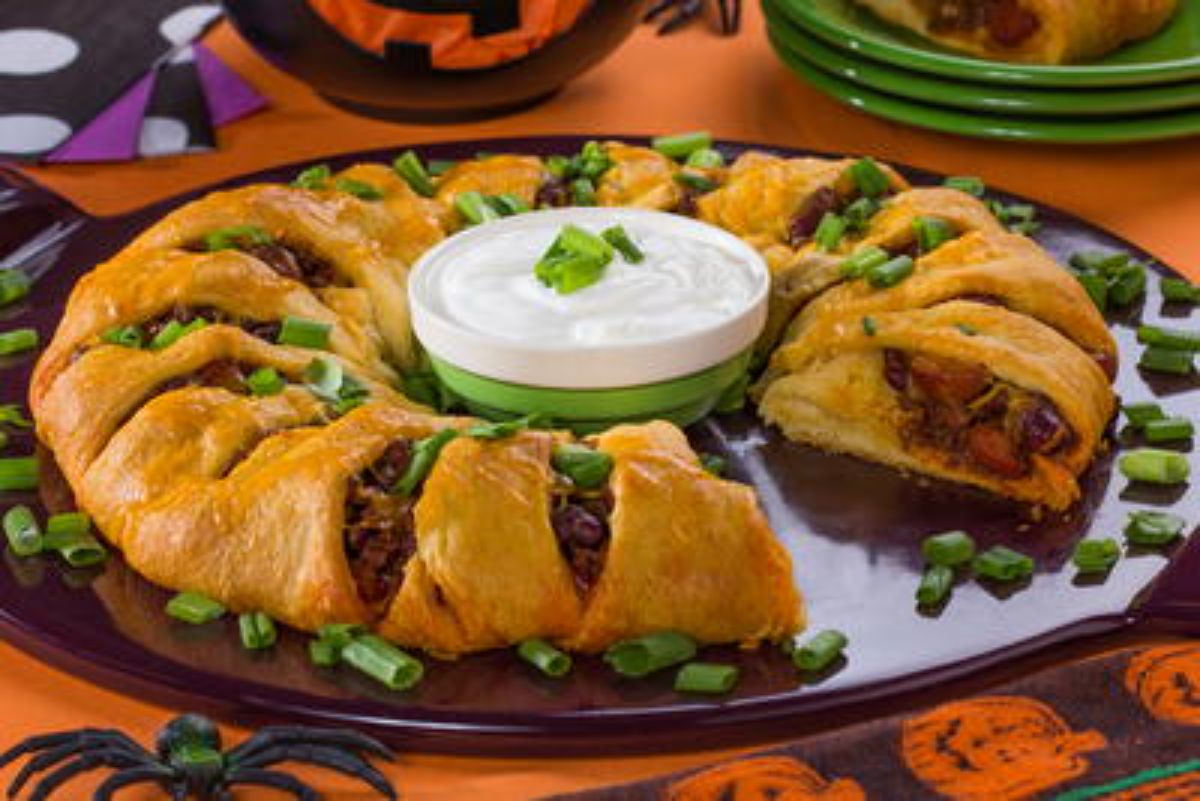 Scrumptious chili cheese dog ring on a tray.